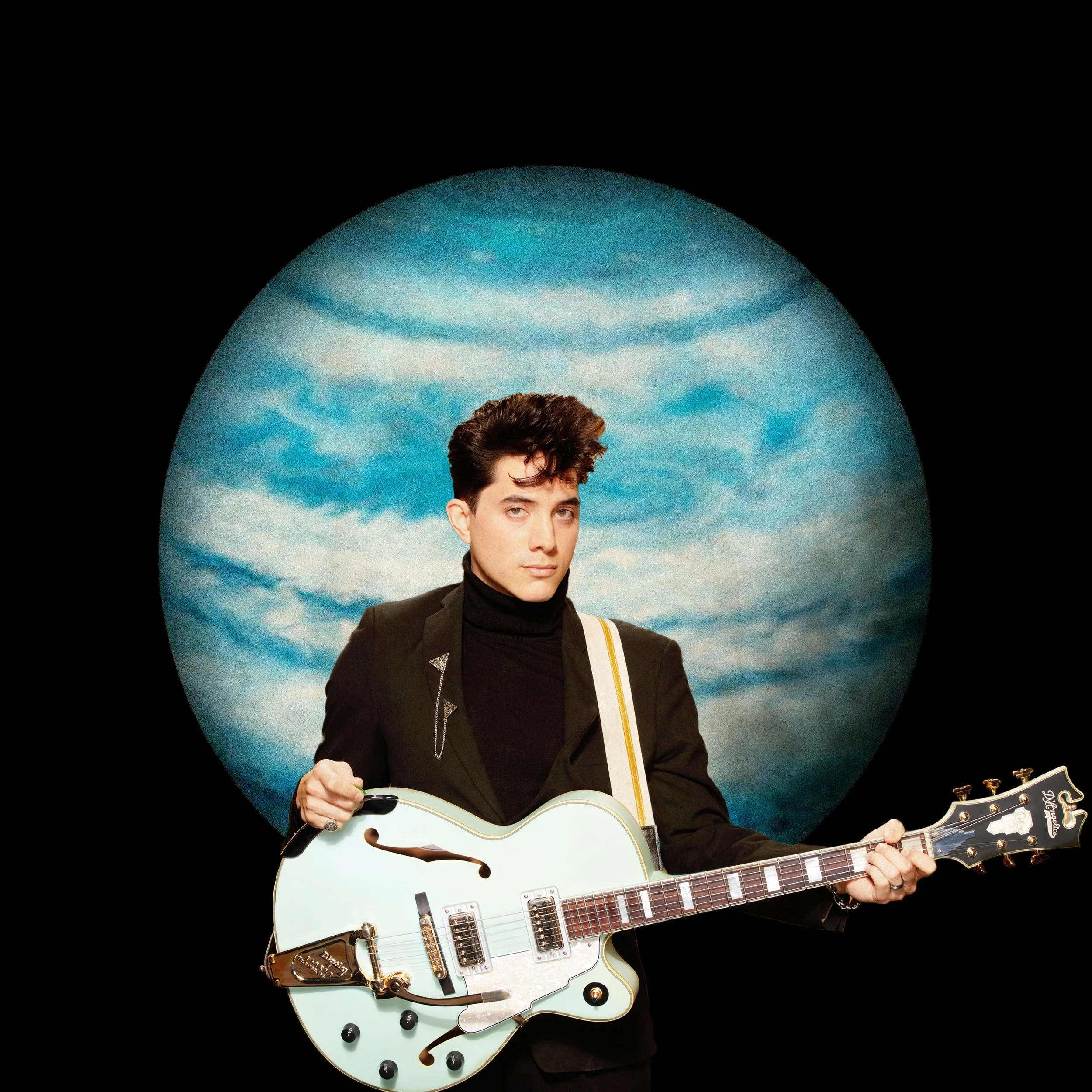 JAYKO holding a guitar in front of a blue-tinted planet Jupiter
