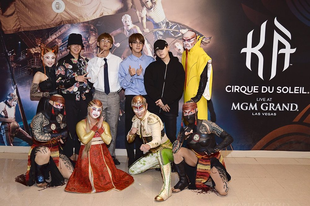  j-hope, V, Jin, and Suga posing with KA Cirque Du Soleil performers 