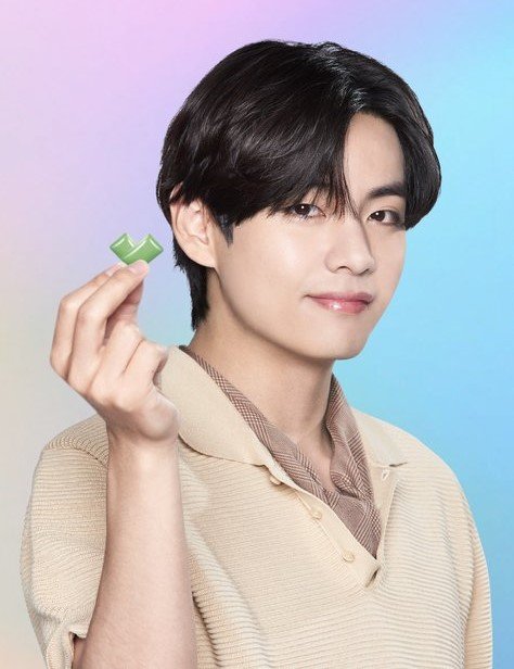 V poses holding with BTS Xylitol gum