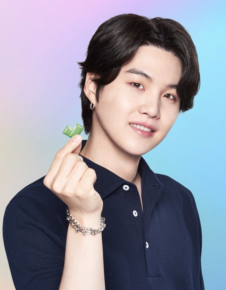 Suga poses holding with BTS Xylitol gum