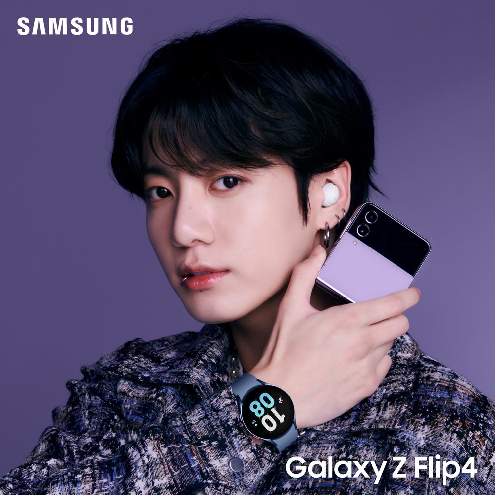 Jungkook wearing the new Galaxy Watch 5 and Buds 2 Pro while holding the new Z Flip4