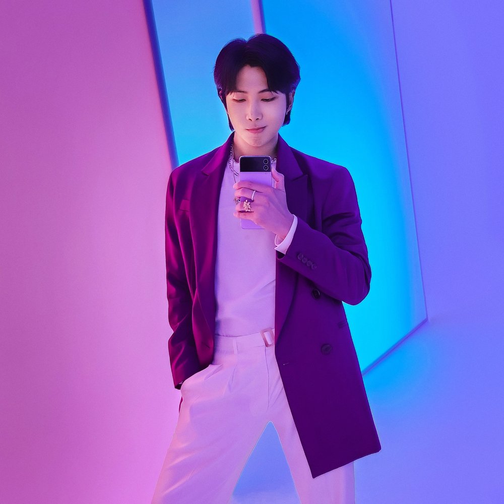 RM in purple holding the Galaxy ZFlip4. 