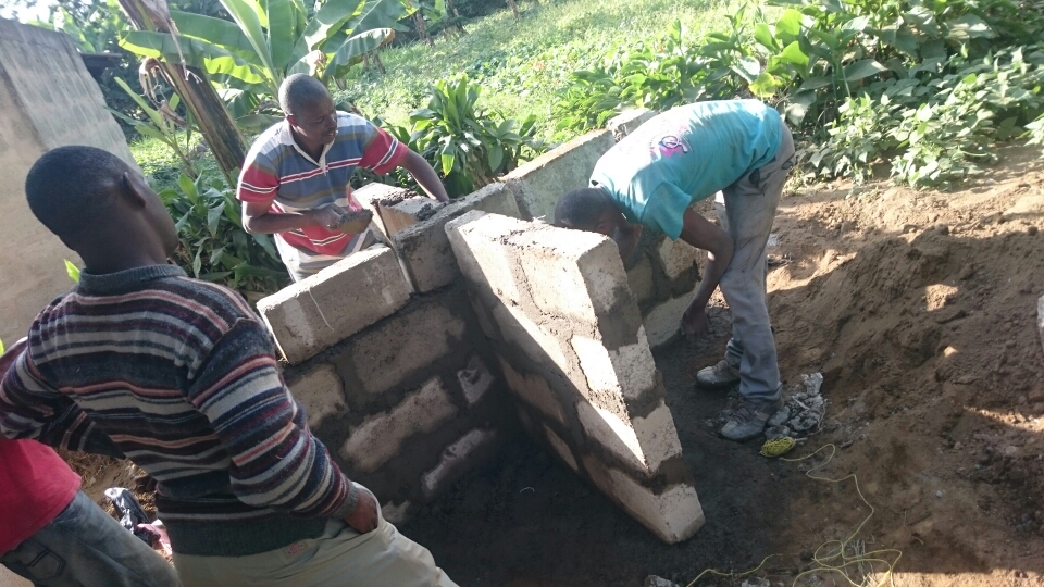 Local construction workers laying the foundation for a water tank riser. 