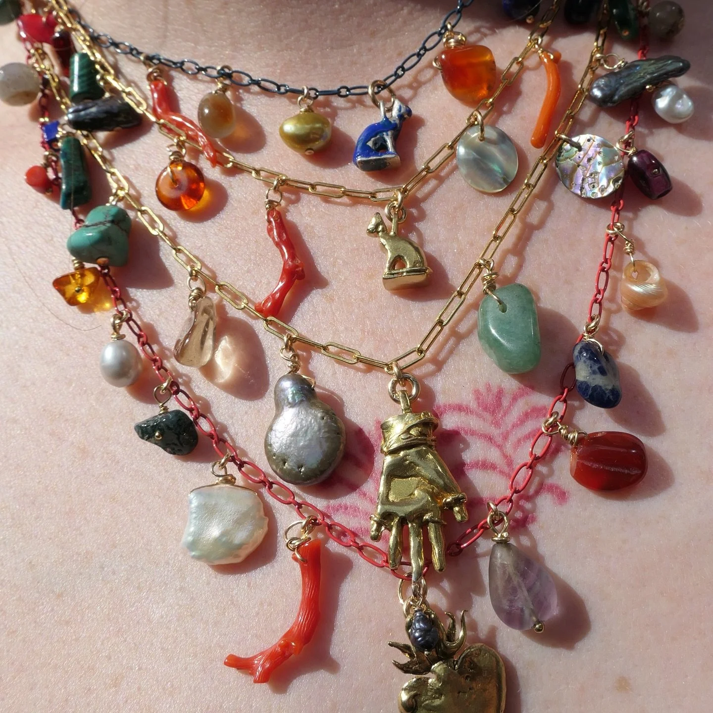 A peep at some of the one-off necklaces available in the shop! 🫡 ⭐ My mate &amp; housemate @kitma makes cool music &amp; kindly wore my charm necklaces in the garden so I could demonstrate what they look like when they&rsquo;re worn.
If you look clo
