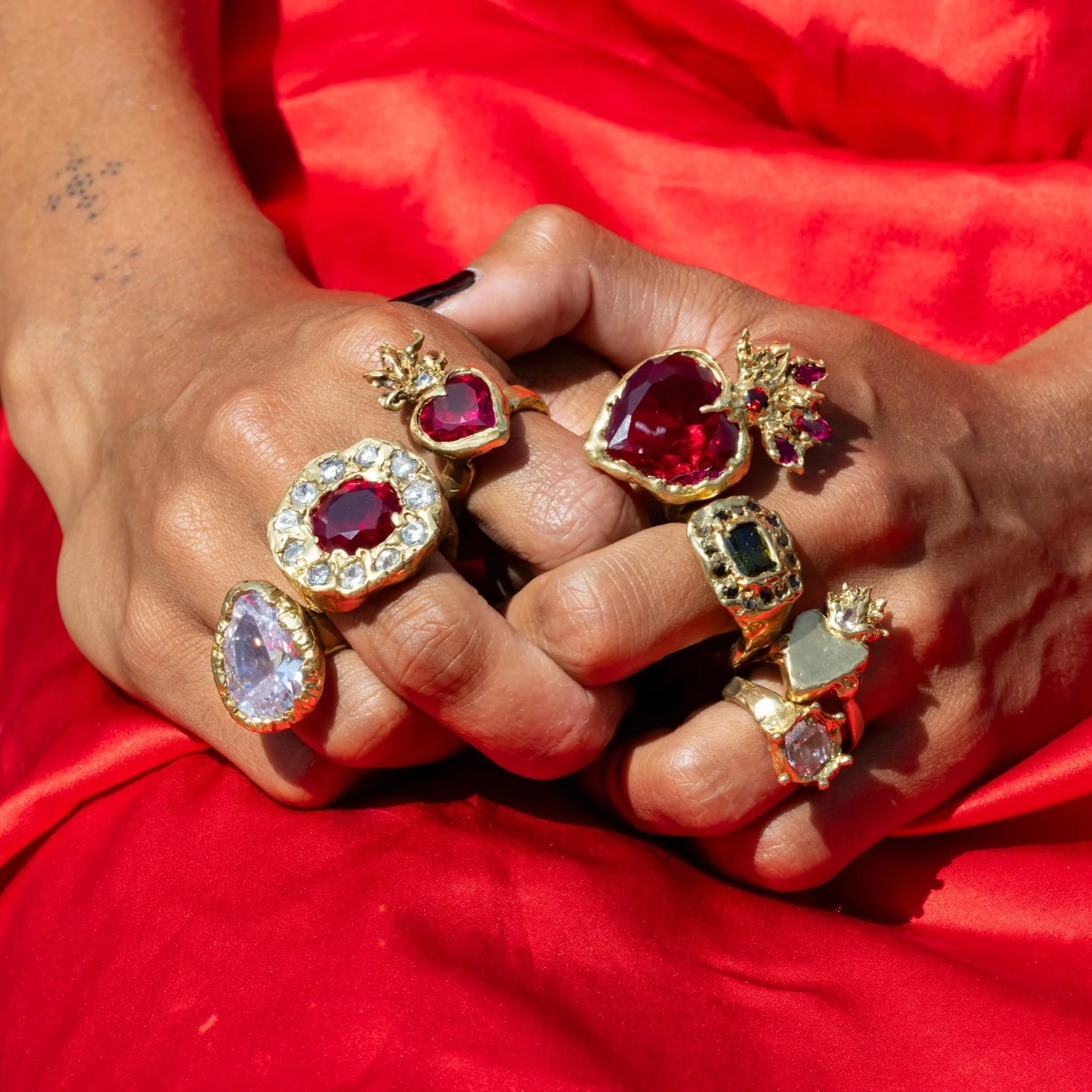 I&rsquo;m obsessed with the images we took outside the studio, and this clutch of cast-in-place Treasure Rings upon Cora&rsquo;s lap of vintage red silk. 🔥 💎 🌹 Who&rsquo;s coming to try on the rings this Sunday?? It&rsquo;s rather fun to put a loa
