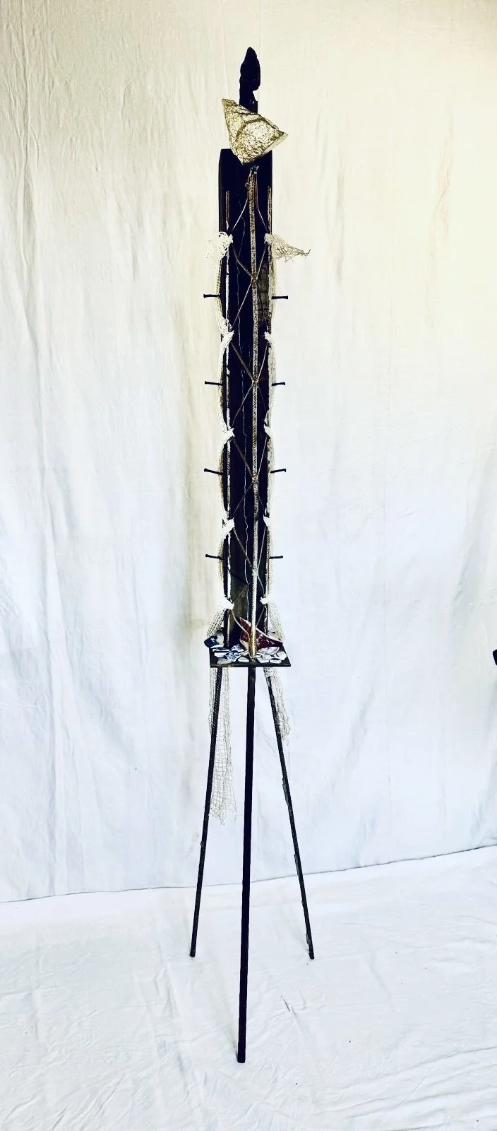   La Sentinale, 2026   Natural stone, chestnut ceiling beam fragment, reclaimed forged iron, construction rebar, china fragments, reclaimed steel.  2.1m high x 30cm wide × 35cm deep 