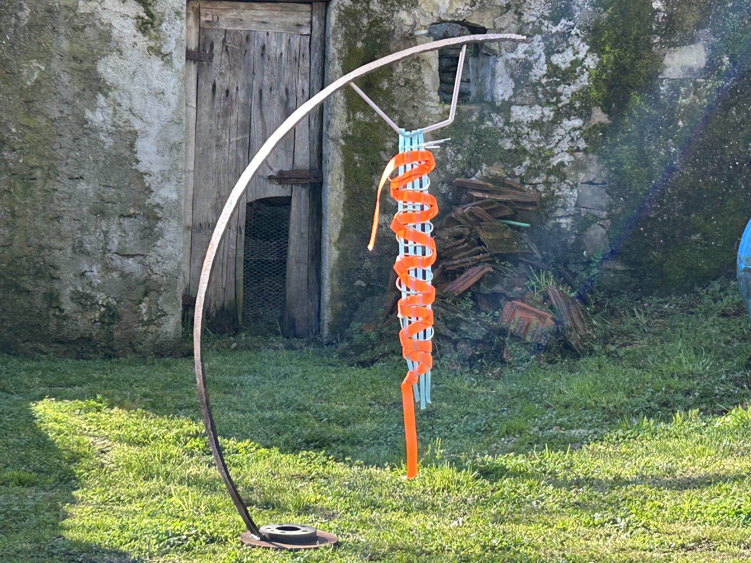  I Find Myself, too, 2026  Sculpture: Vintage steel agricultural and car parts, salvaged aluminium bars, gilding and acrylic paint.  Weaving: Reclaimed supermarket packaging, electrical wire, neon webbing straps  1.6m high × 8cm wide × 1.2m deep 