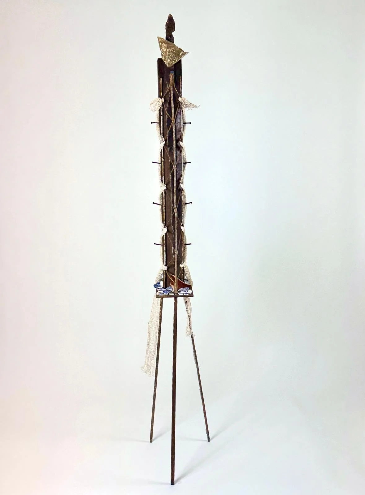  La Sentinale , 2025 Stone, salvaged wood, metal and hand forged iron, domestic detritus, vintage steel, acrylic paint, gilt. 196cm high x 30cm wide x 28cm deep. 