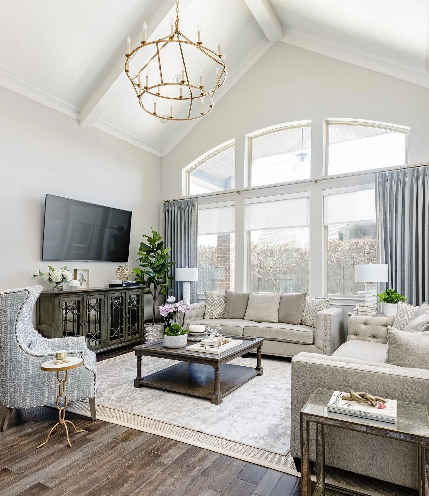 We love a good statement fixture!
This transformation shows the power of paint, window treatments, and lighting! We kept the same layout and worked with the existing sofas and tv console.
📷: @collscottphoto 
#vwbellatransitional #livingroomdecor #h