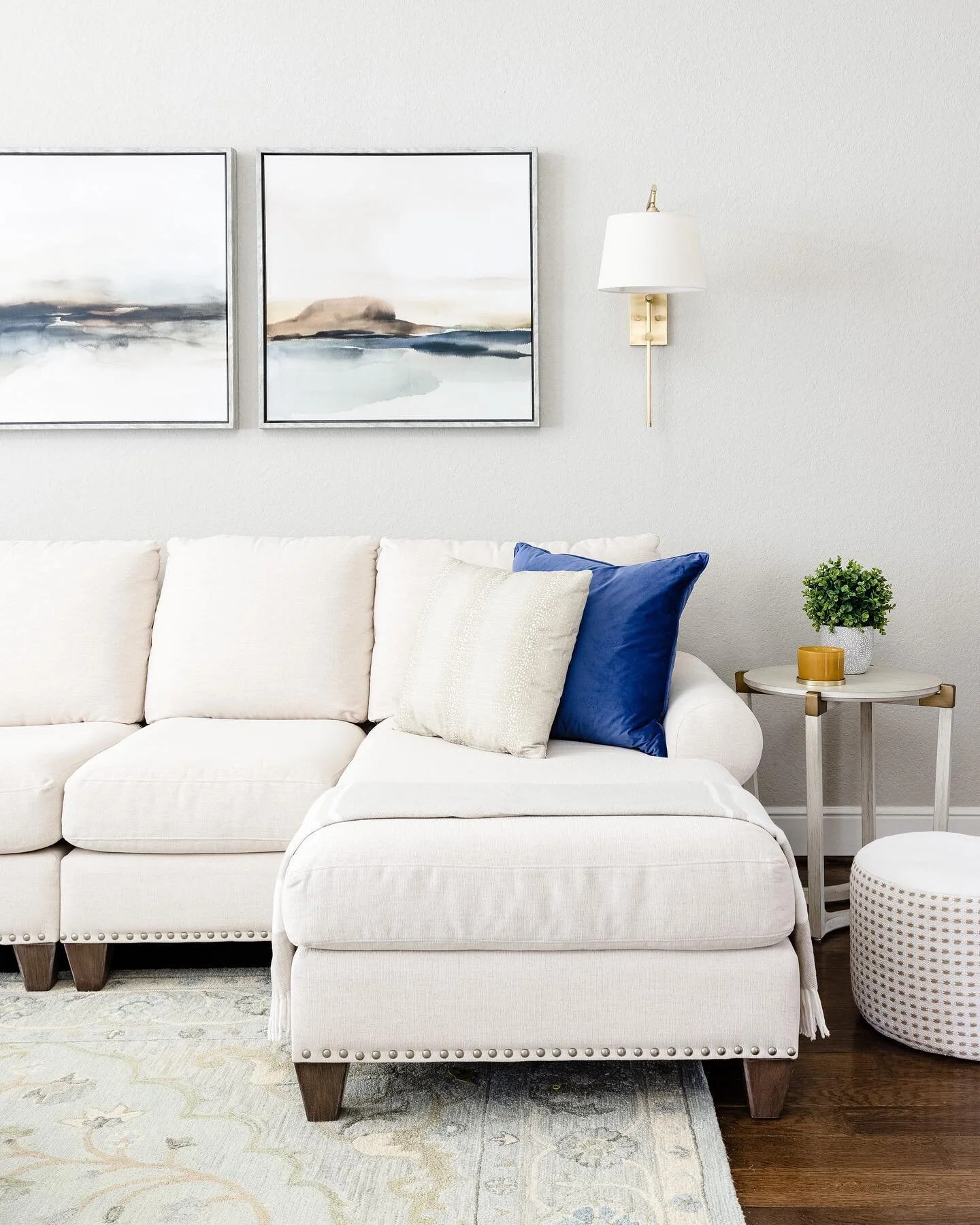 When you have high ceilings and a large spanning wall, you need large art (or a series of them)! We found this triptych to go the distance we needed. Each of these pieces are 33” square, and keep the neutral palette the client wanted with hints