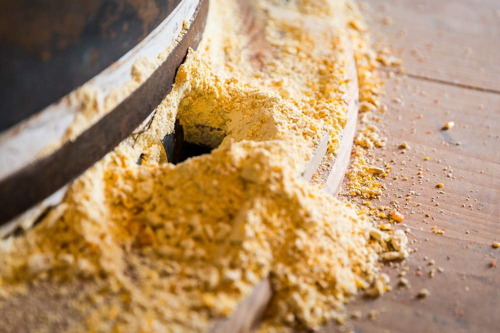 Grist (ground grain) coming out of spout