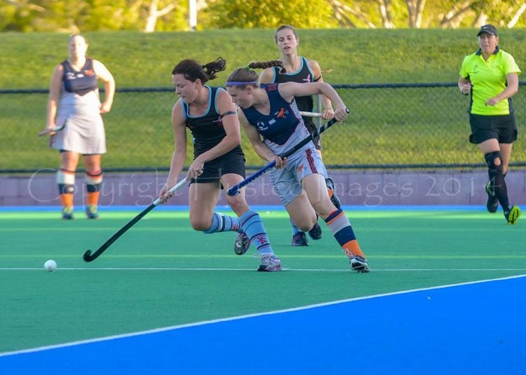 Phoebe playing field hockey internationally