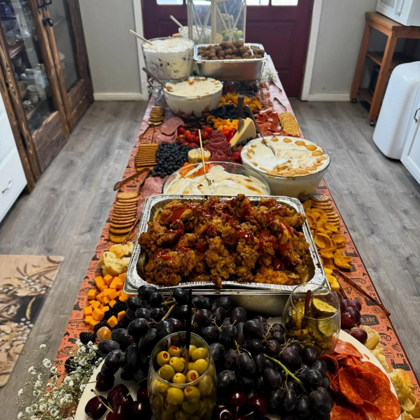 Lovely grazing table with creamy fiesta corn dip, nashville hot chicken tenders, jerk meatballs and trifles in our banana pudding and wedding cake flavors. Email info@tablefor2catering.com if we can cater for your next event!
