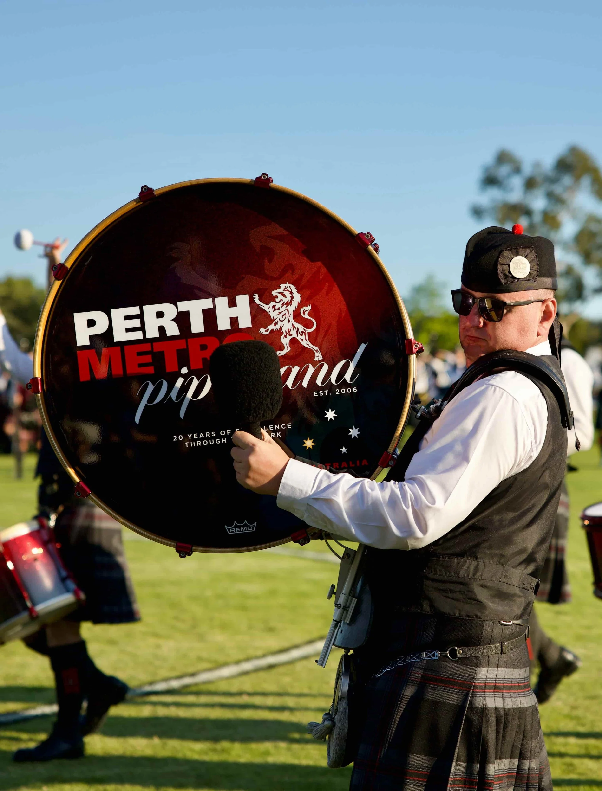 bass drummer playing the perth metro pipe band bass drum in perth western australia