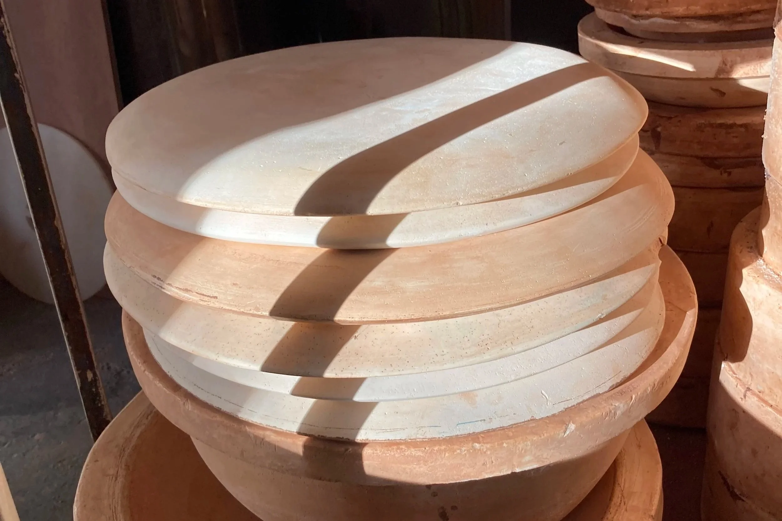 Stack of plaster drape moulds ready for platter workshop in Brighton Ceramic Studio