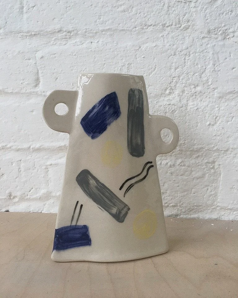 Handmade  bottle vases with handles on display in ceramic workshop