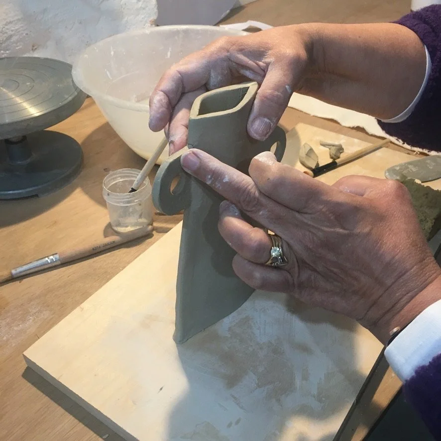 Beginner learning hand-building techniques in pottery class