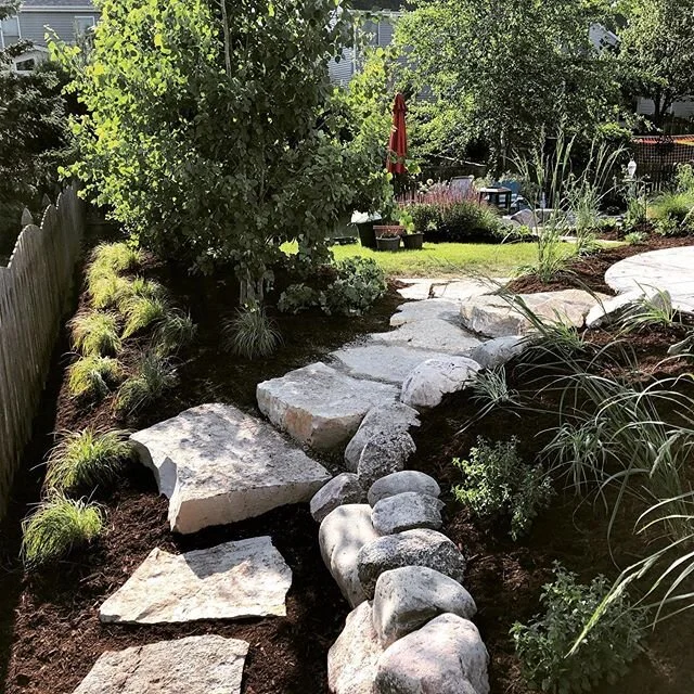 Heading in to the backyard and into summer! First view of the complete backyard! #innlandscape #perennialgarden #limestonesteppers
