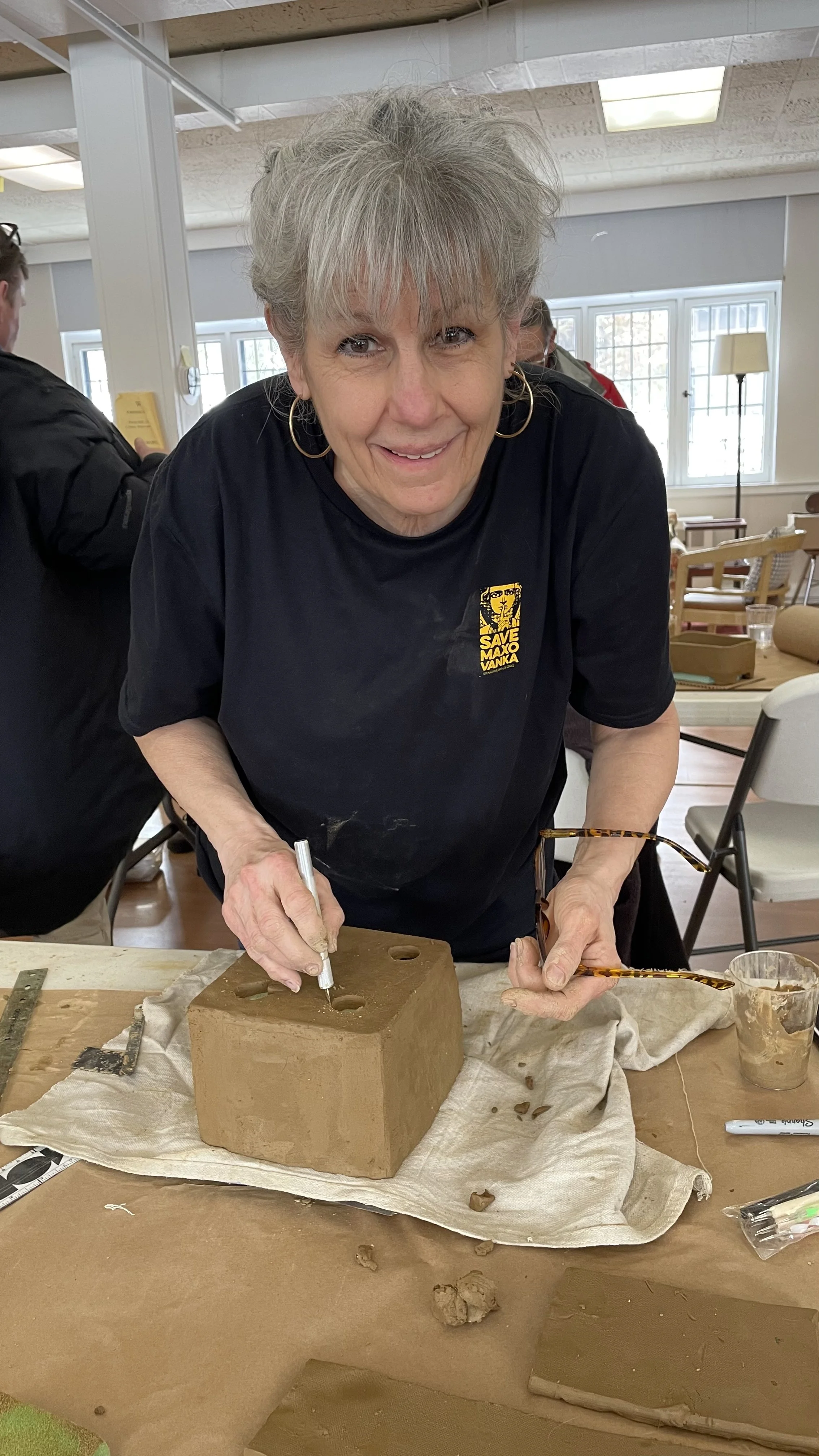 A woman crafting her hand-built bonsai pot