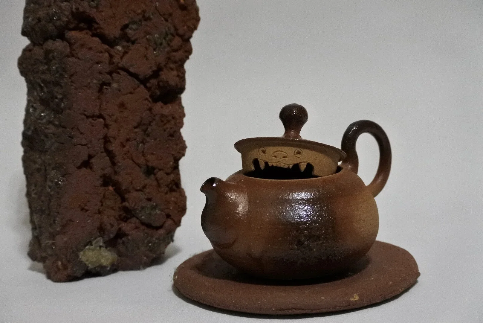 Wood-fired teapot next to wood-fired brick
