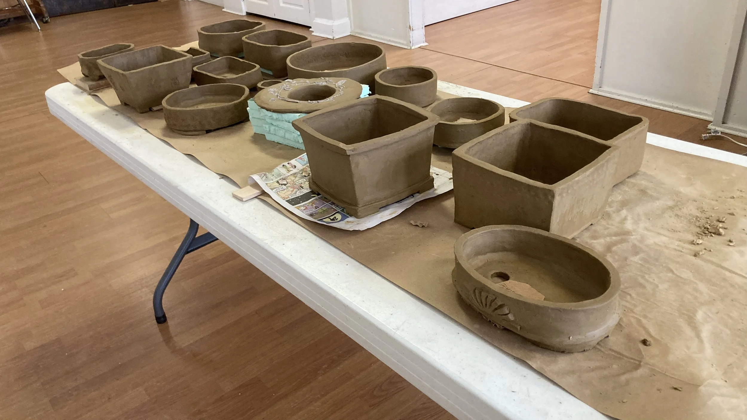 A variety of freshly made bonsai pots drying