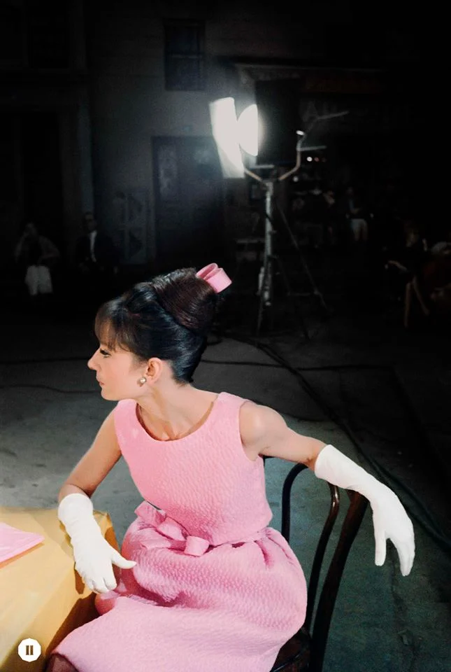 Audrey wears a pink dress with matching ribbon and elegant white gloves, 1962 ©BOBWILLOUGHBY