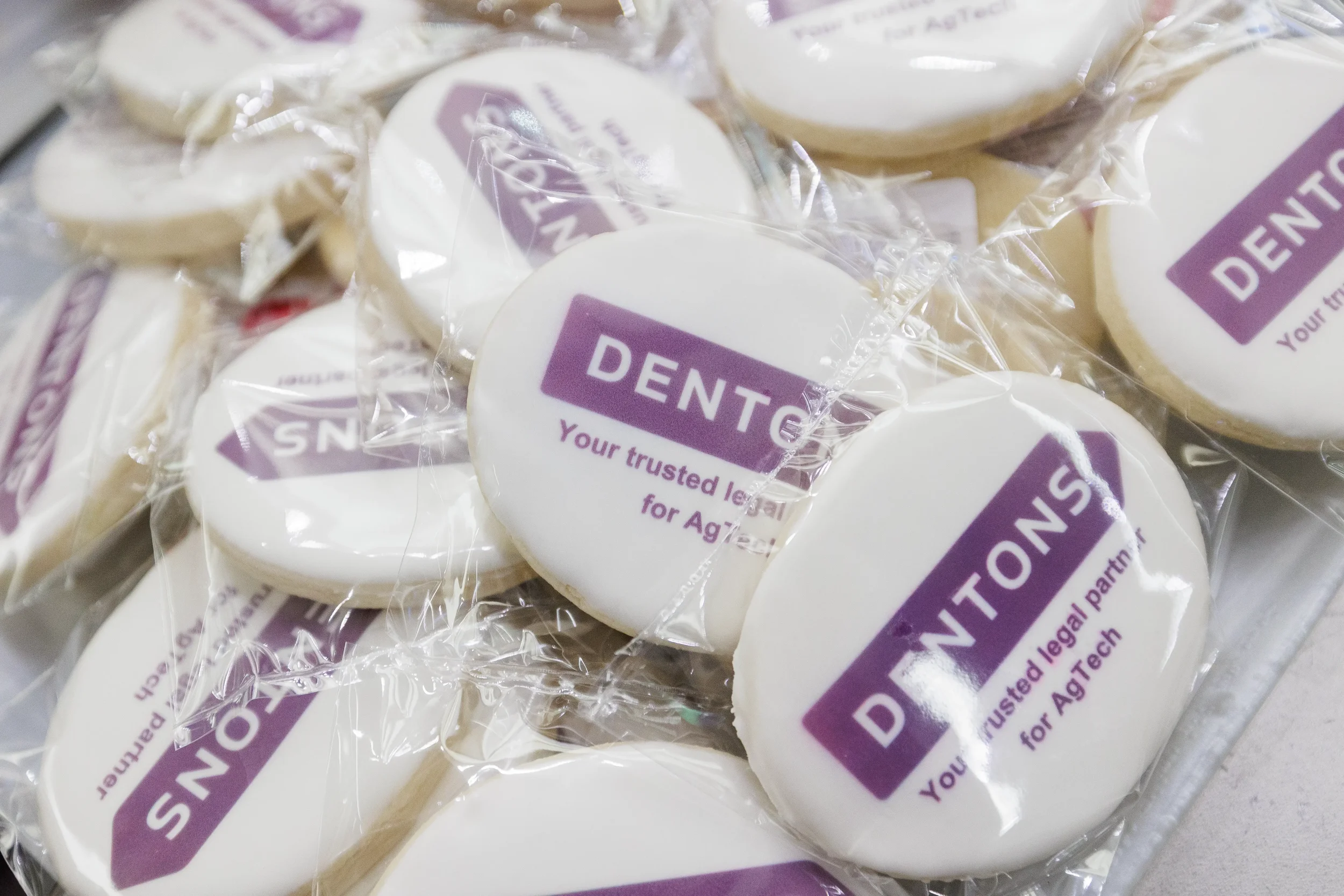 Individually wrapped branded sponsor cookies displayed at catering station at Chicago corporate conference