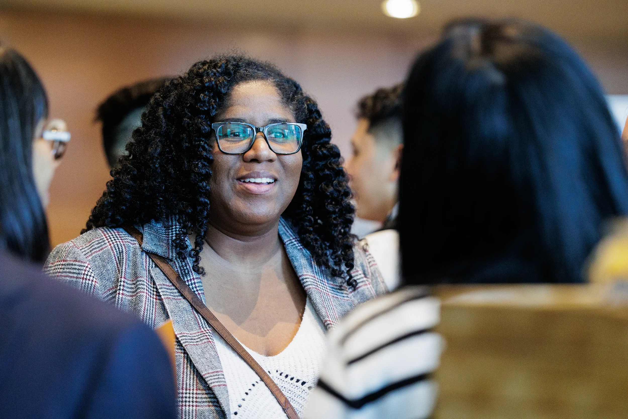 Attendee smiles during networking conversation at Chicago corporate event