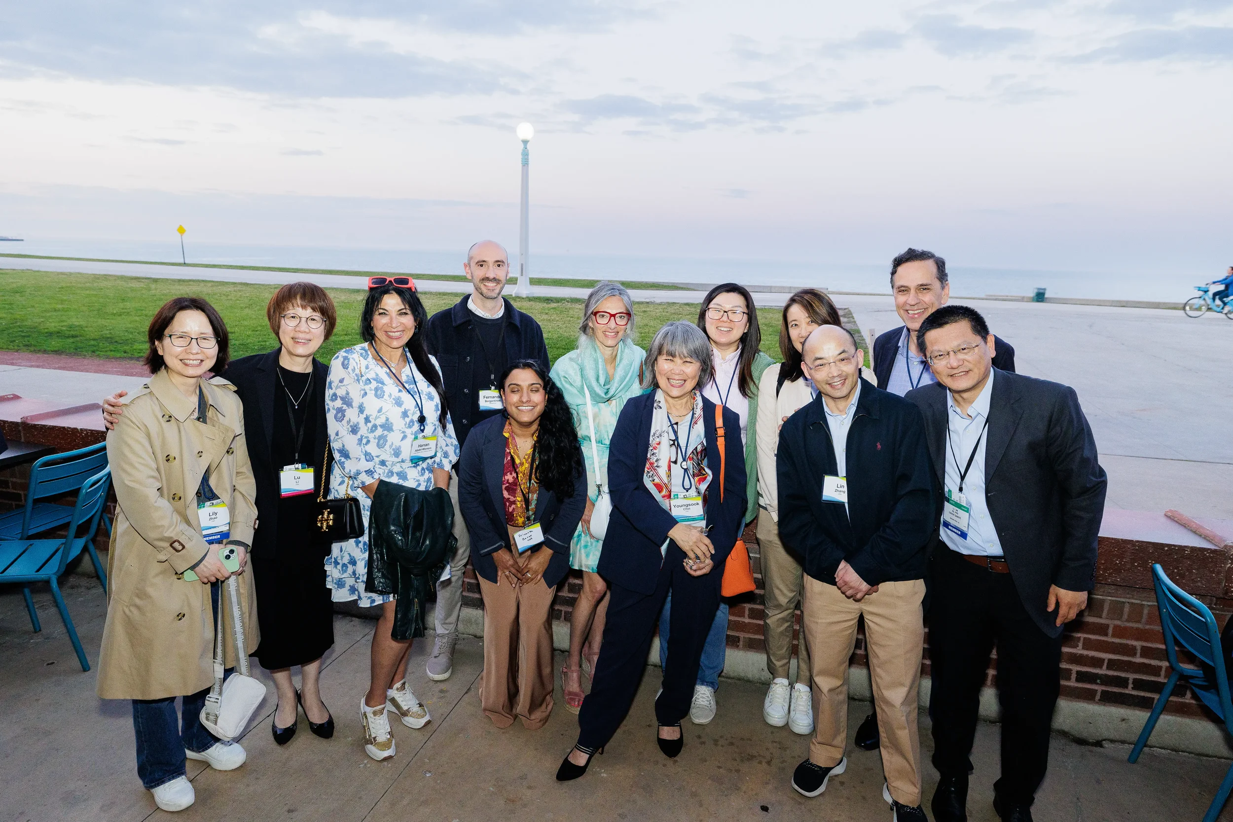 Large group of attendees pose together along the lakefront at Chicago corporate event
