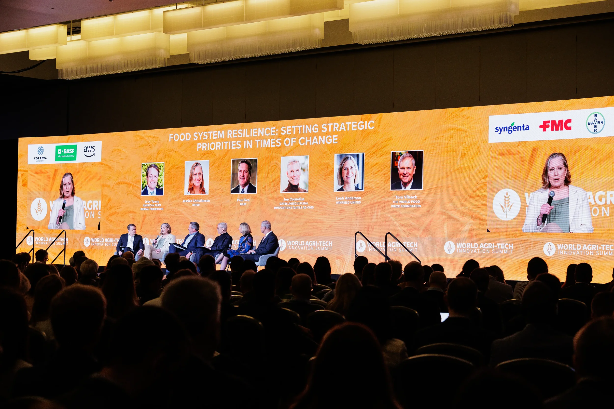 Panelists discuss strategic priorities on stage with screen backdrop at Chicago industry summit