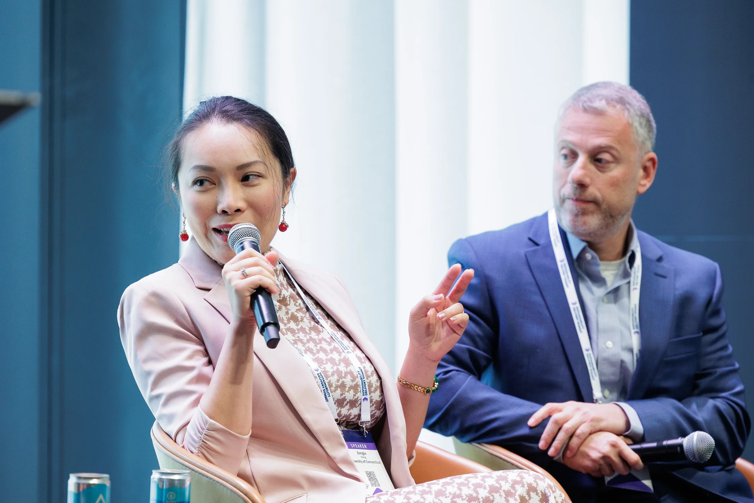 Panelists seated with microphones during discussion on stage at Chicago industry conference