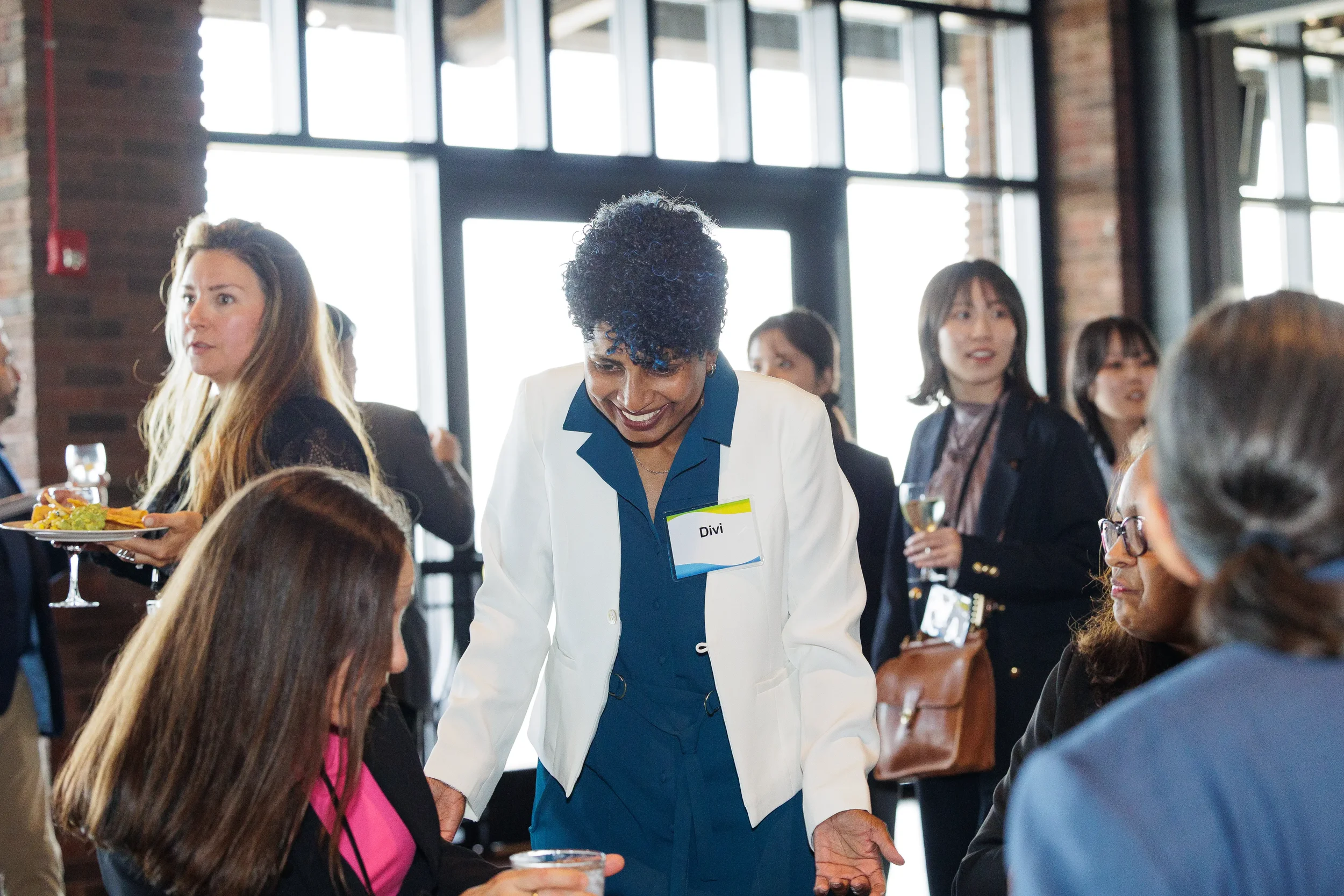 Attendees converse and network during reception at Chicago industry conference event