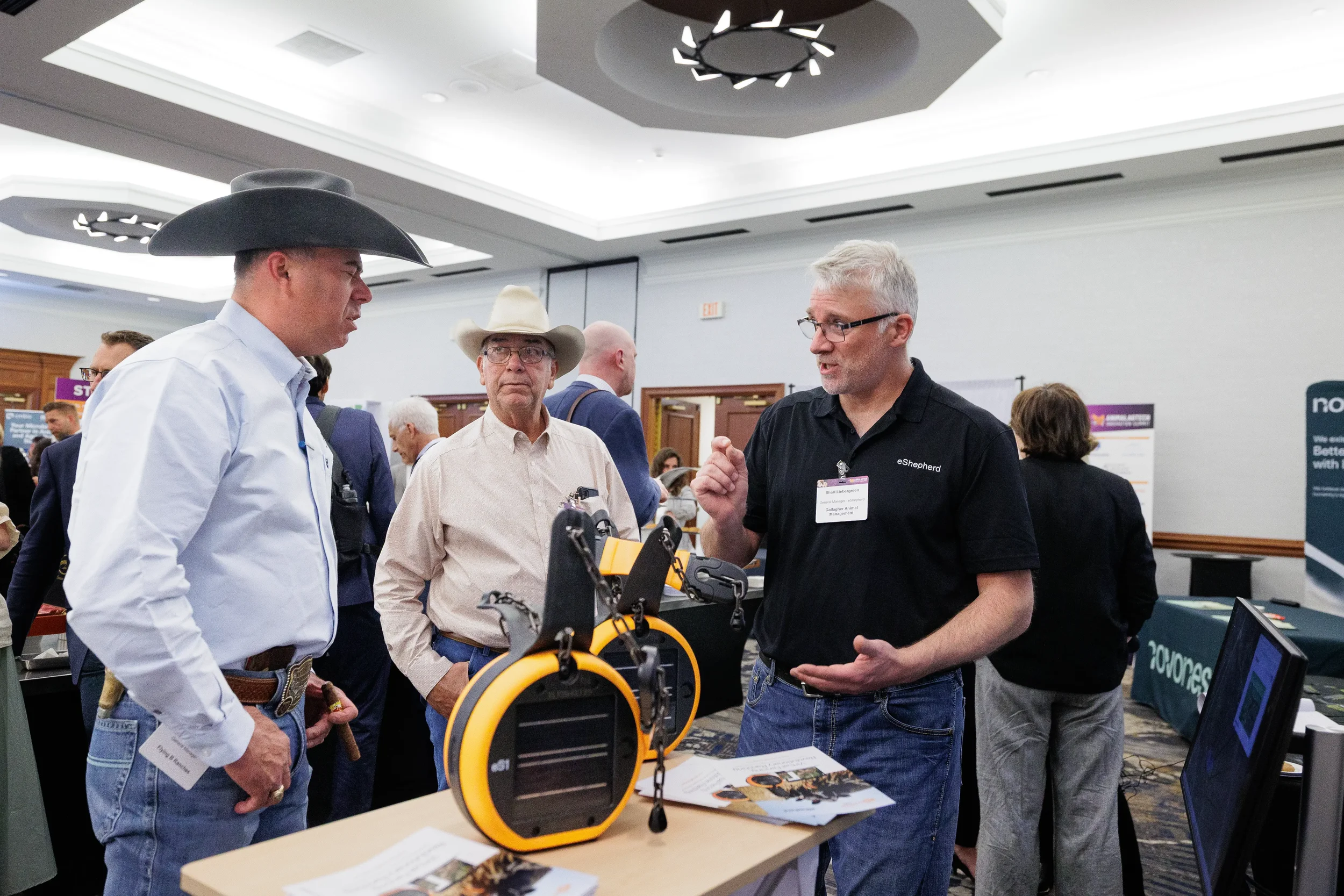 Attendees examine product demonstration at expo booth during Orlando industry conference