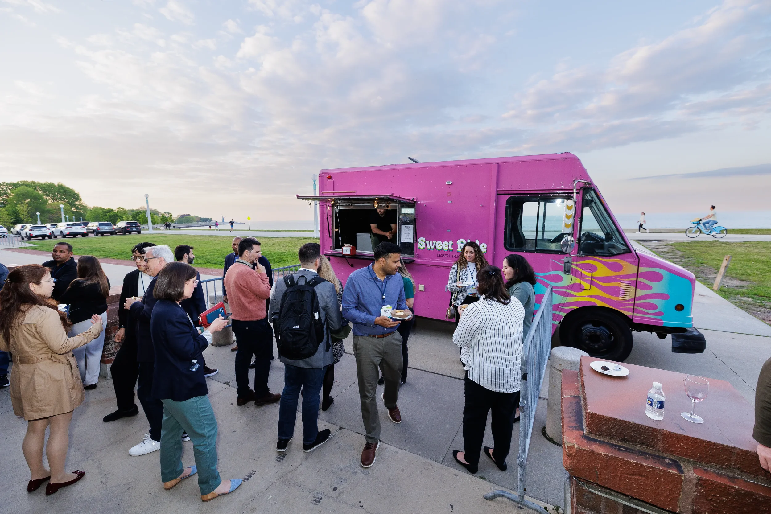 Attendees gather at dessert truck along lakefront during Chicago corporate event