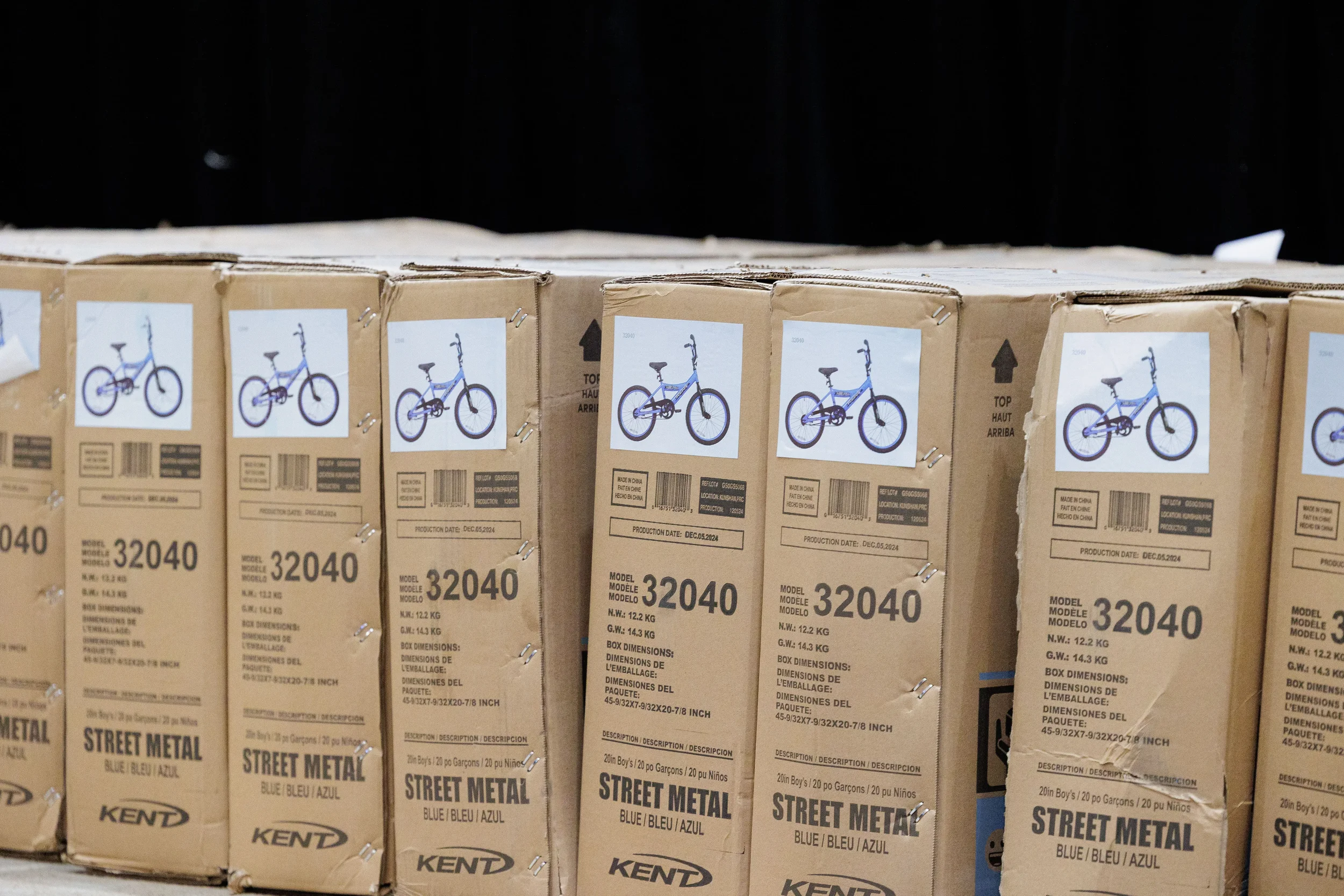 Row of boxed bicycles staged for team building charity activity at Chicago corporate conference