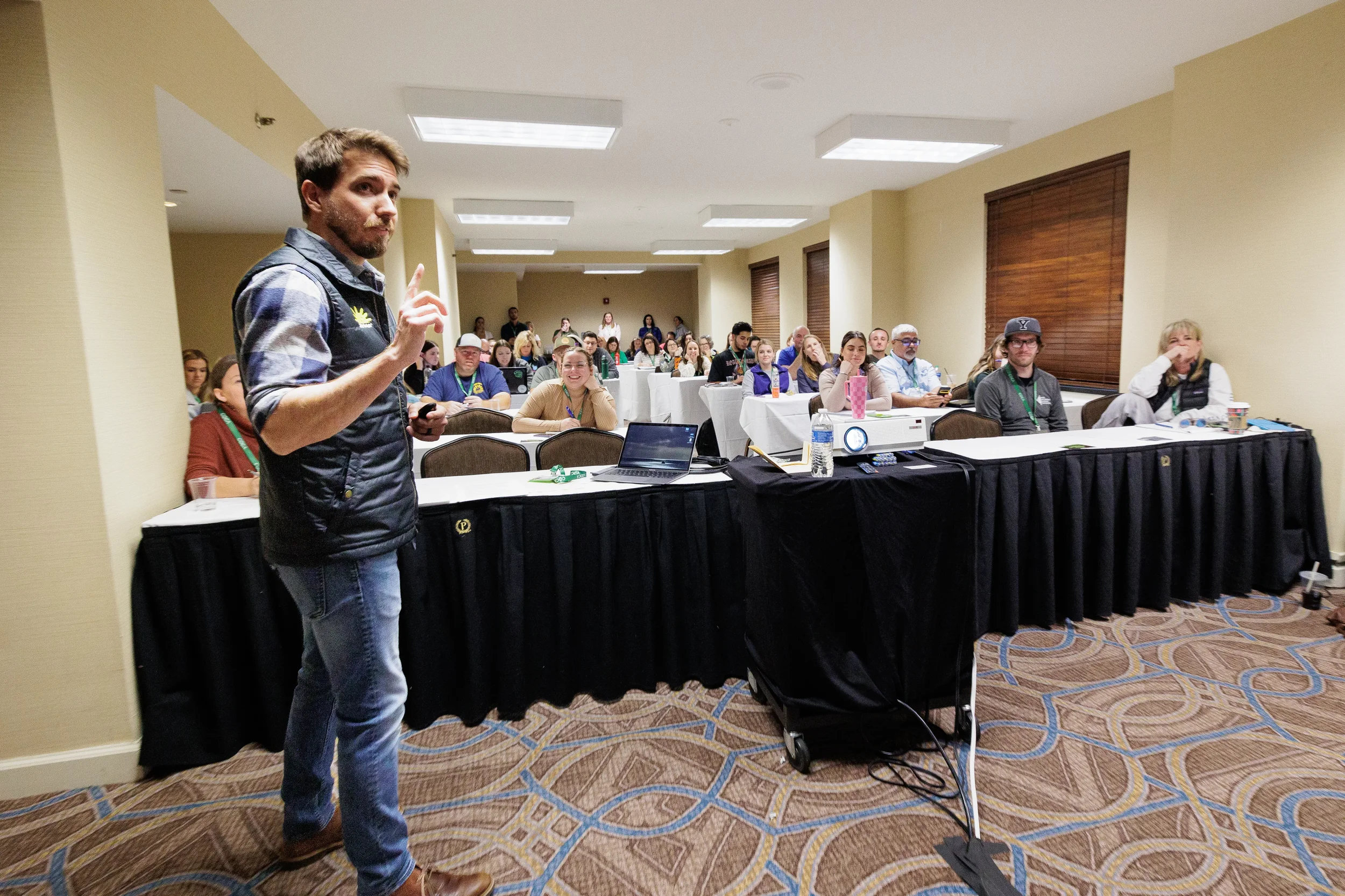 Speaker gestures while leading breakout session for attendees at Orlando conference