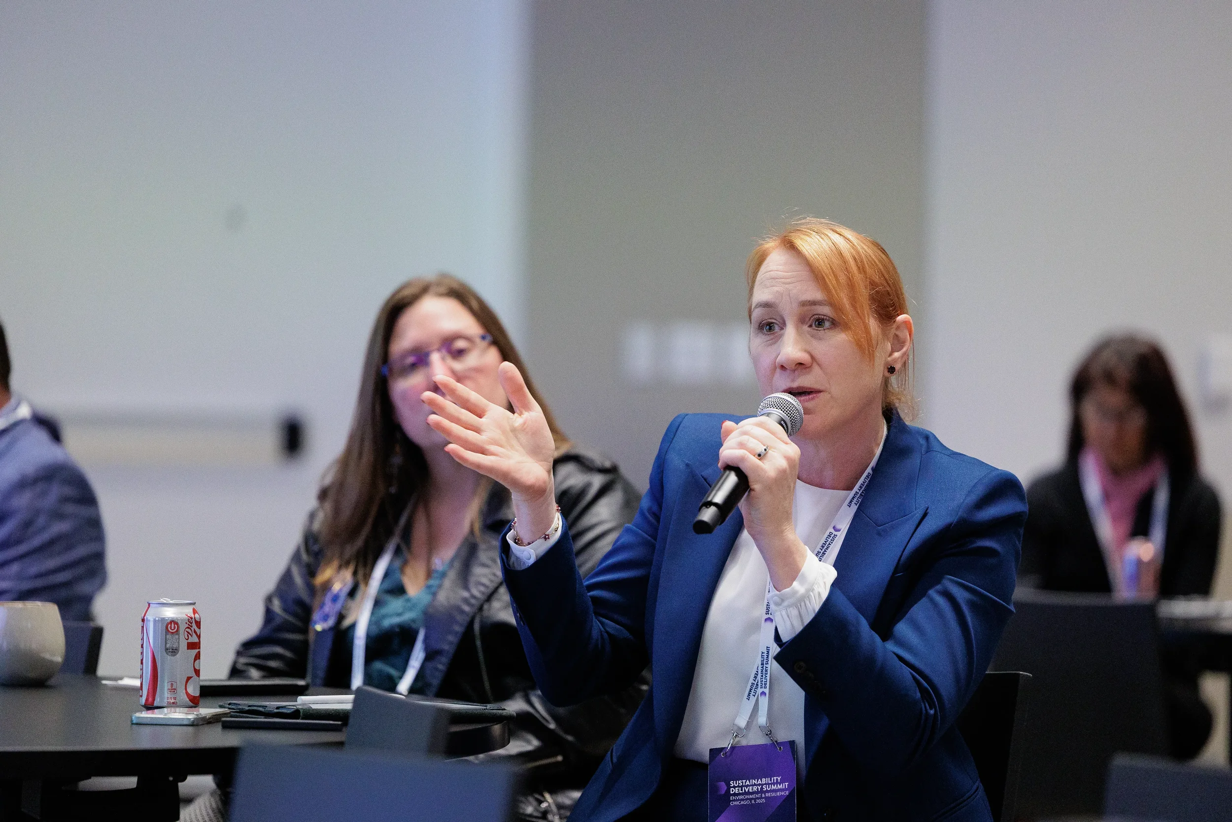 Attendee speaks into microphone during seated session at Orlando corporate conference panel