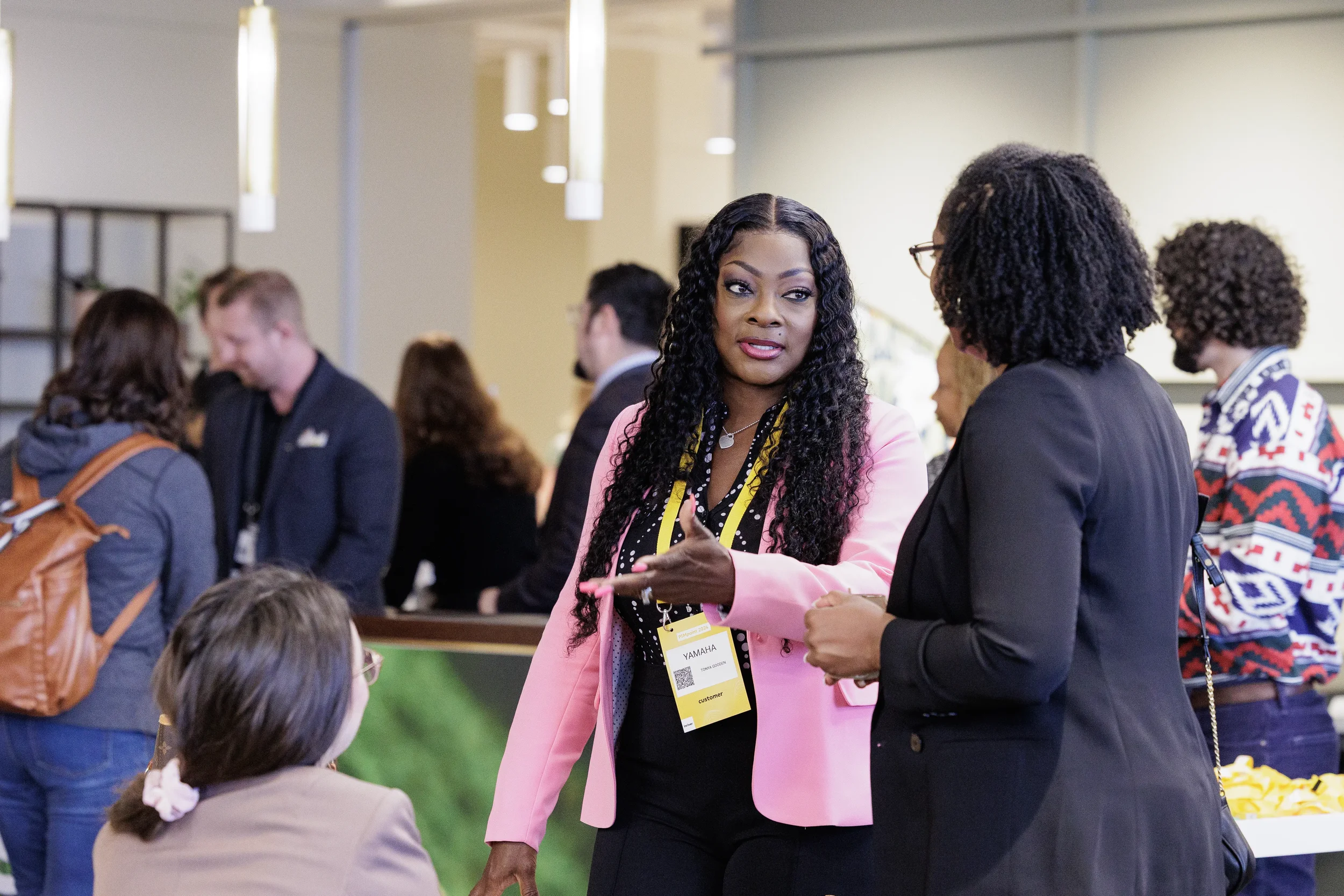Attendees talk during networking break in event lobby at Chicago corporate conference