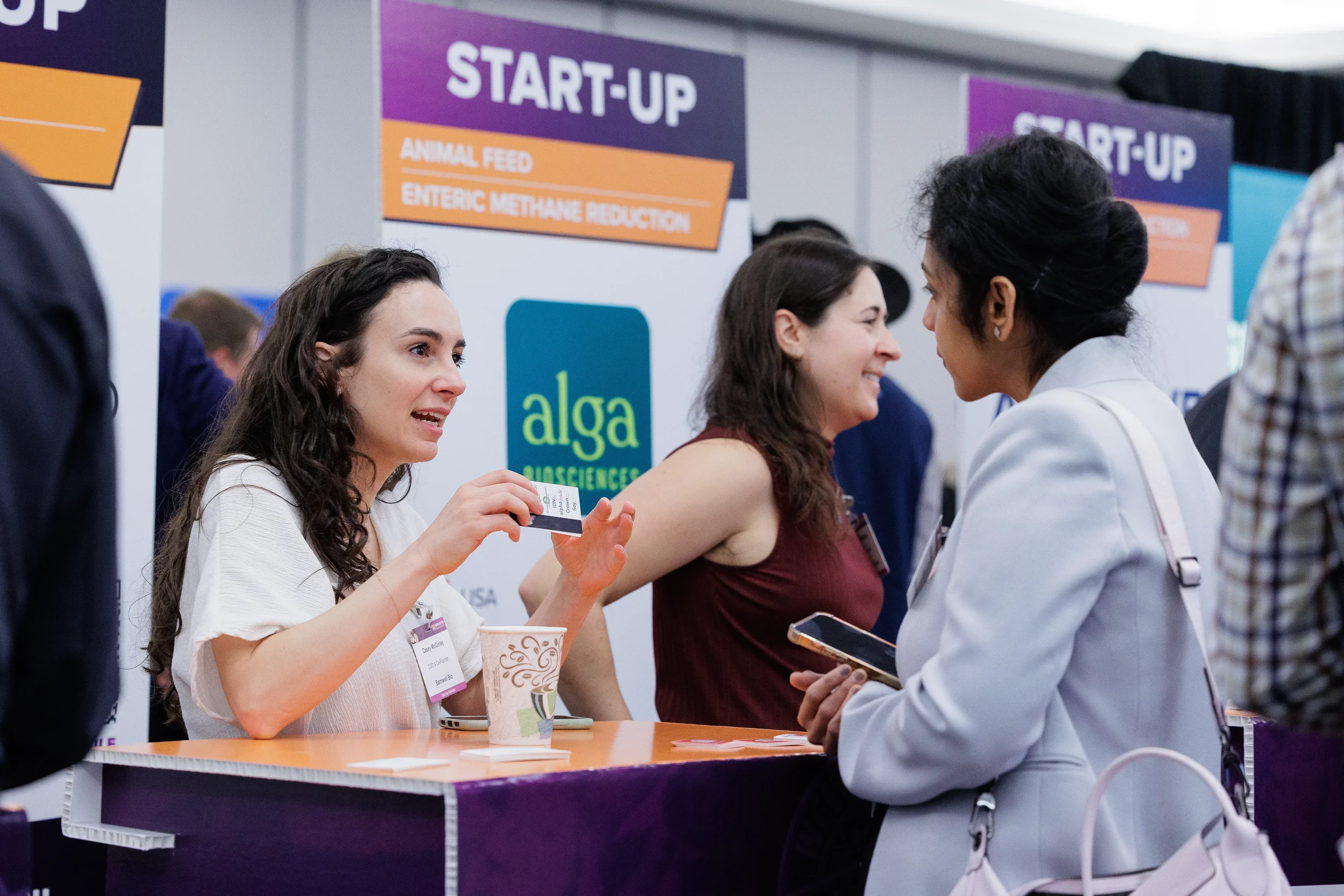 Attendees converse at startup exhibitor booth during Chicago corporate conference