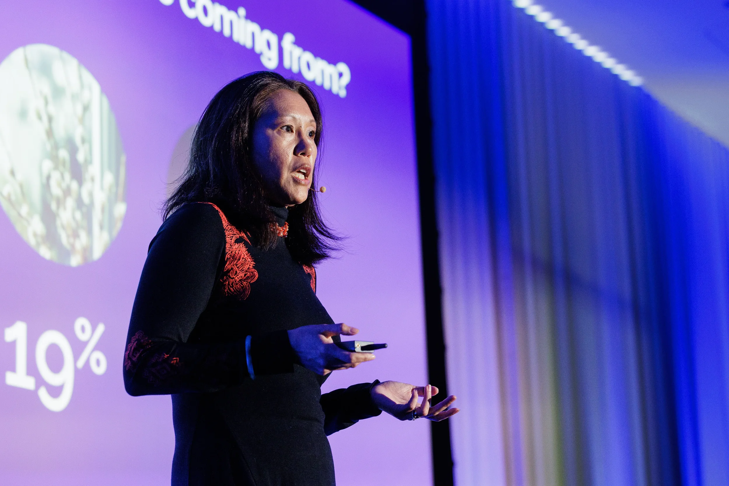 Close-up of speaker with headset microphone gesturing on stage at Chicago corporate conference