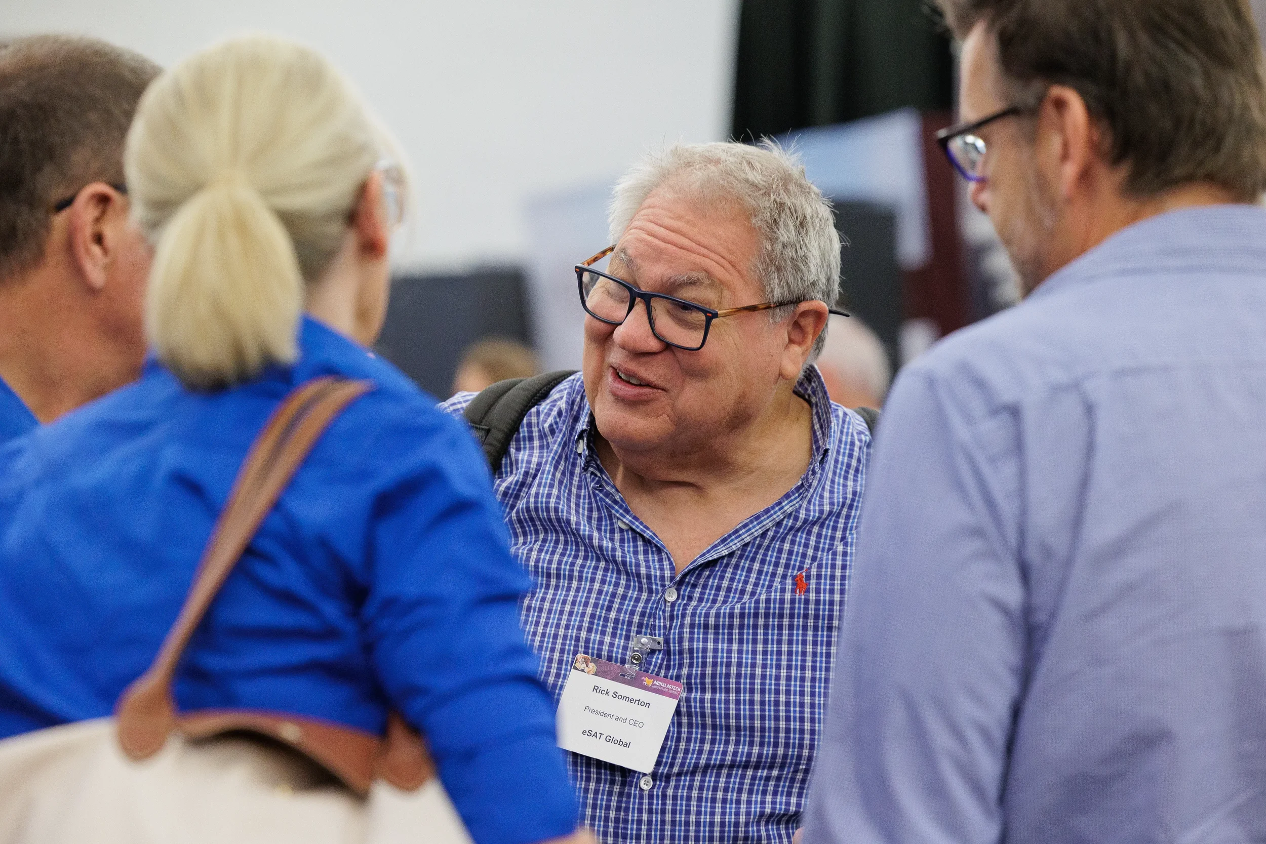 Attendees converse in networking crowd at Orlando industry conference