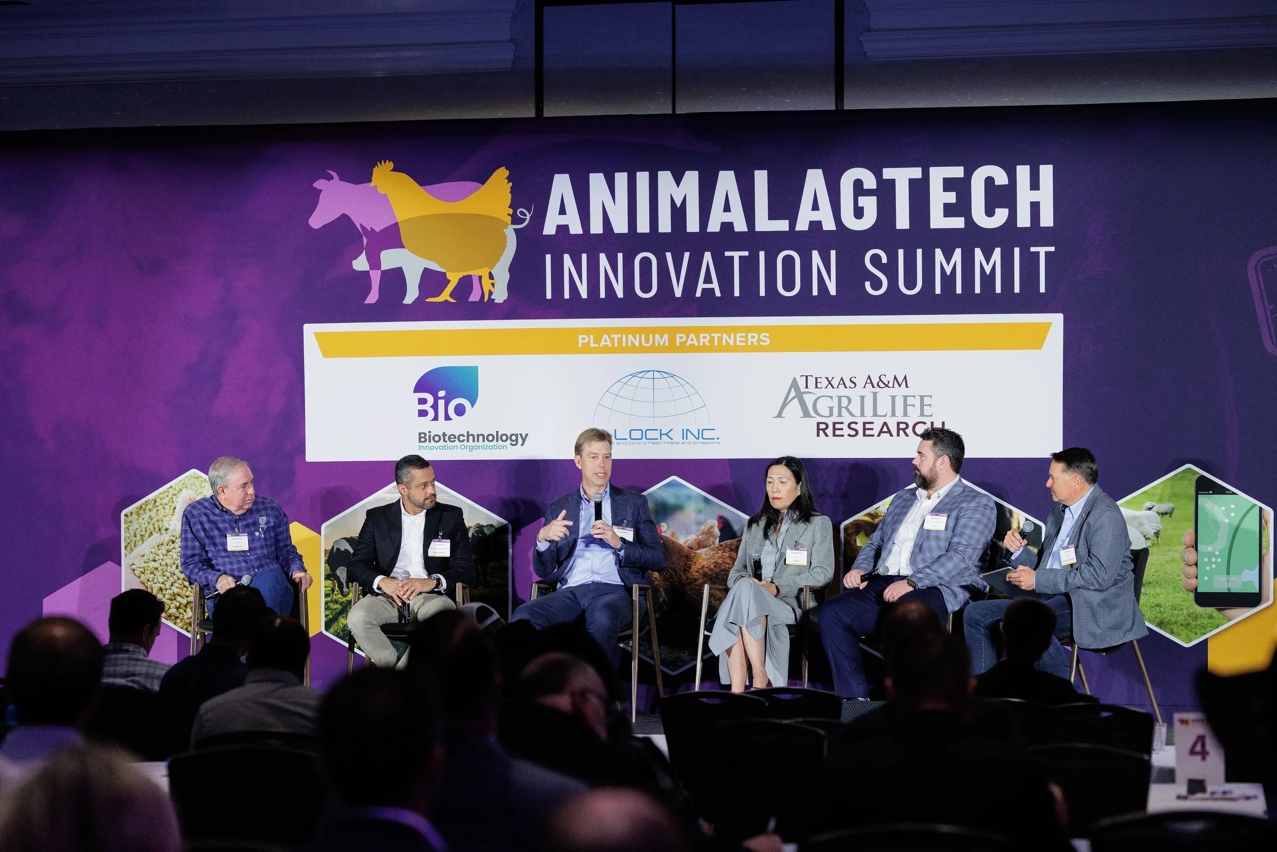 Panel of speakers address audience from branded stage at Chicago corporate summit