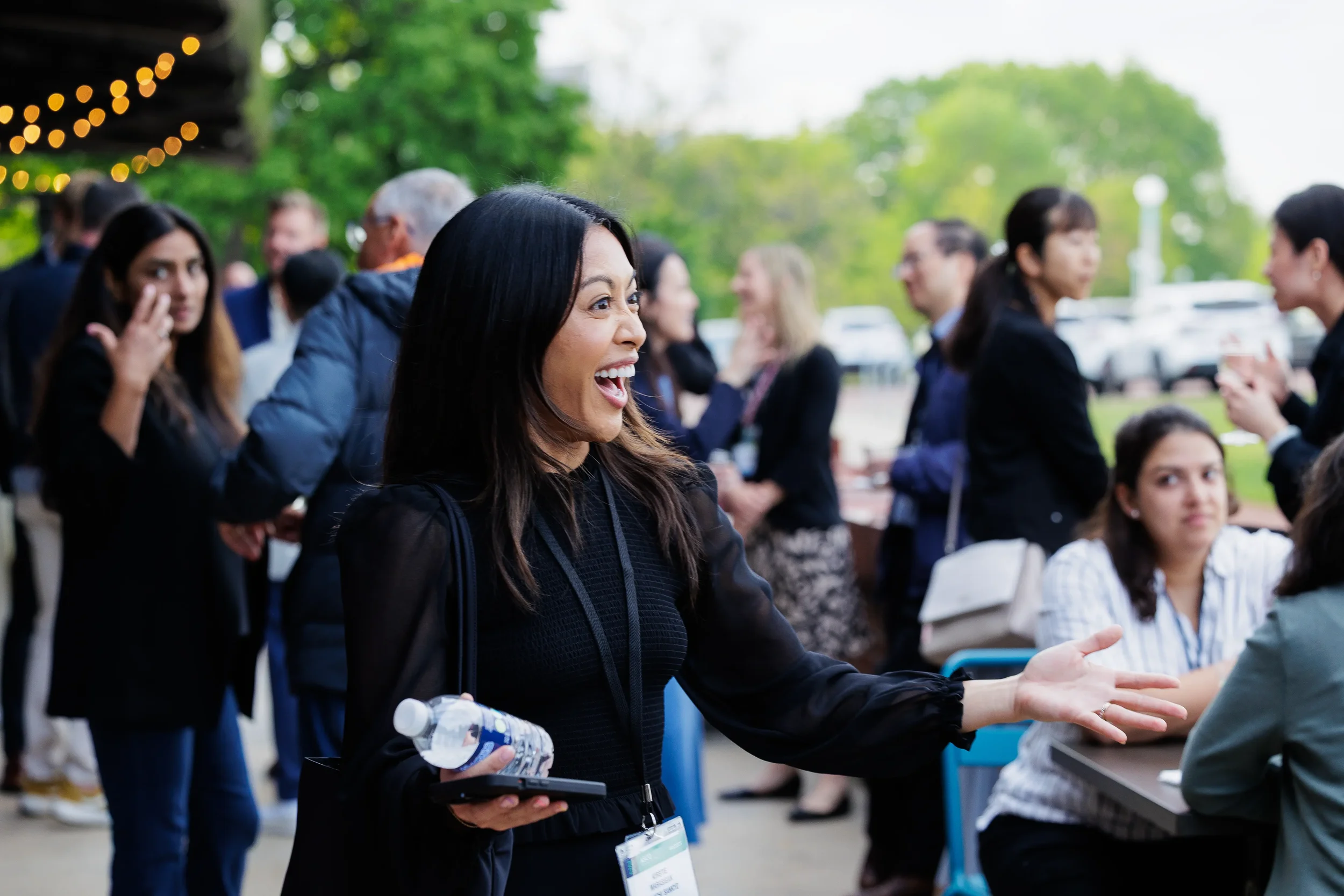 Attendee laughs while greeting others during outdoor reception at Orlando corporate event