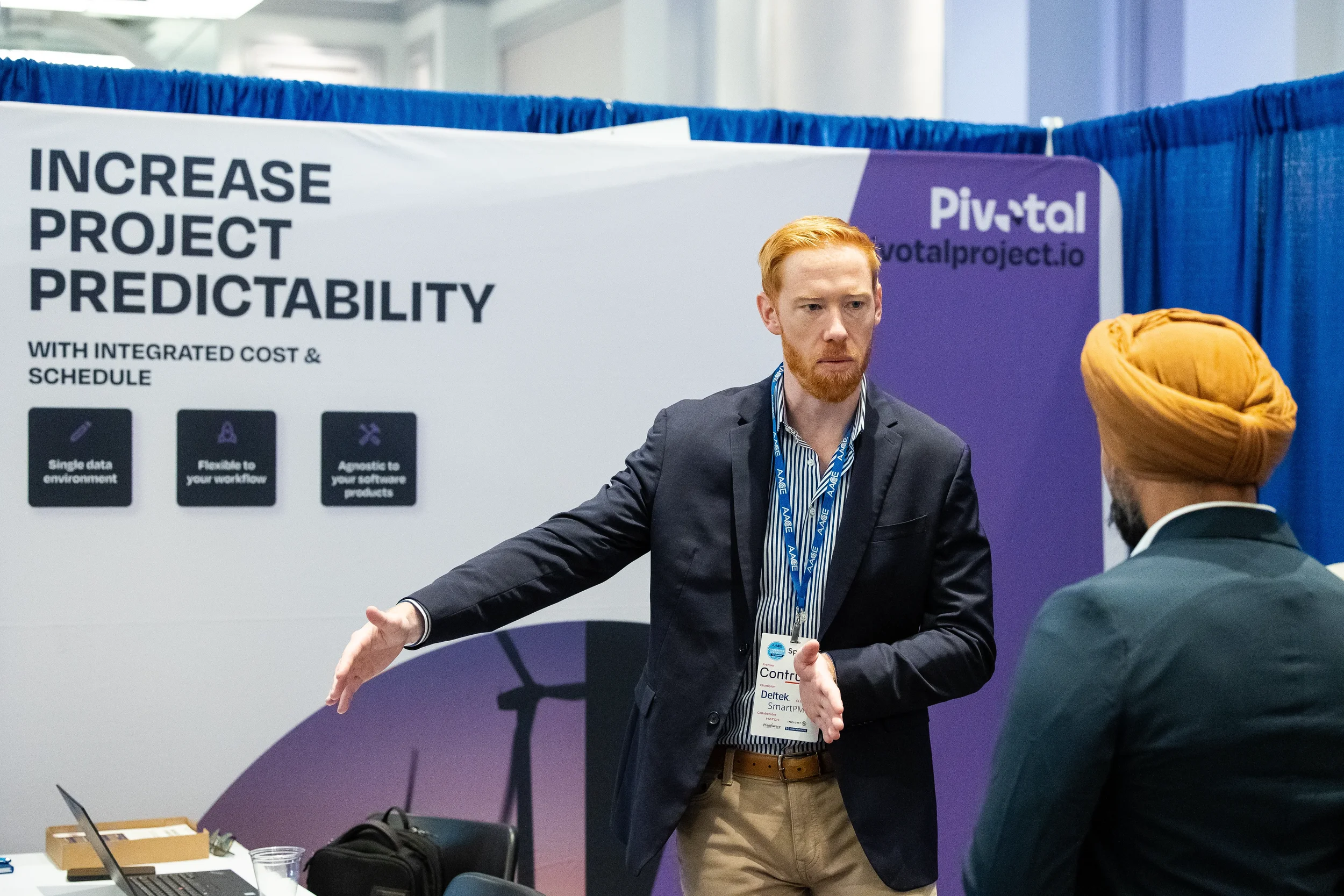 Exhibitor discusses project management solutions with attendee at AACE trade show booth in Orlando