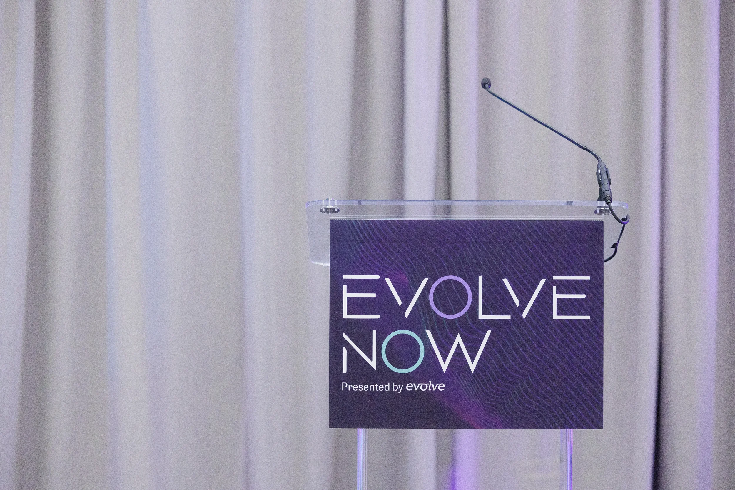 Branded acrylic podium with microphone stands ready on stage at Chicago corporate event