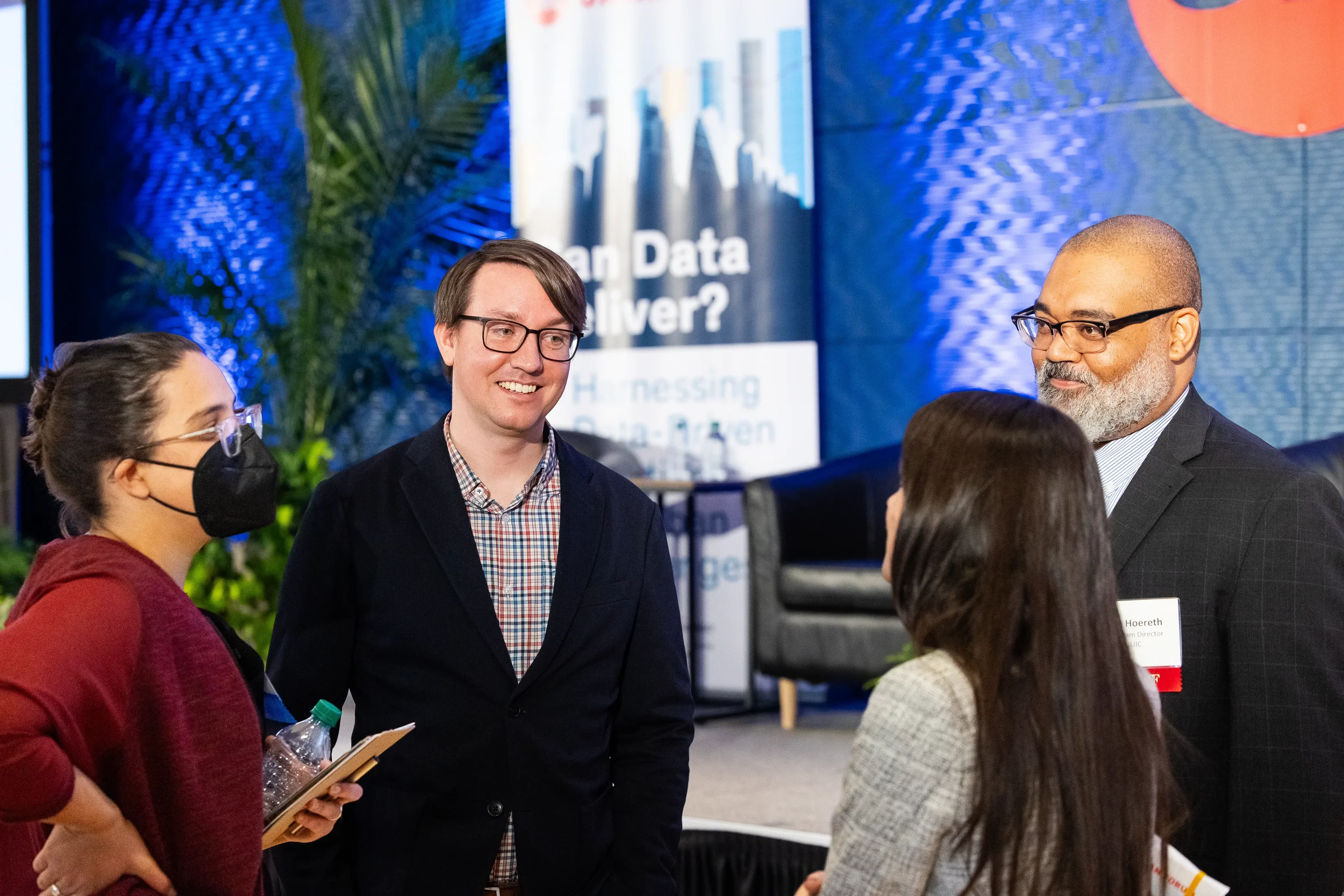 Group of attendees smile during networking conversation at Orlando industry conference