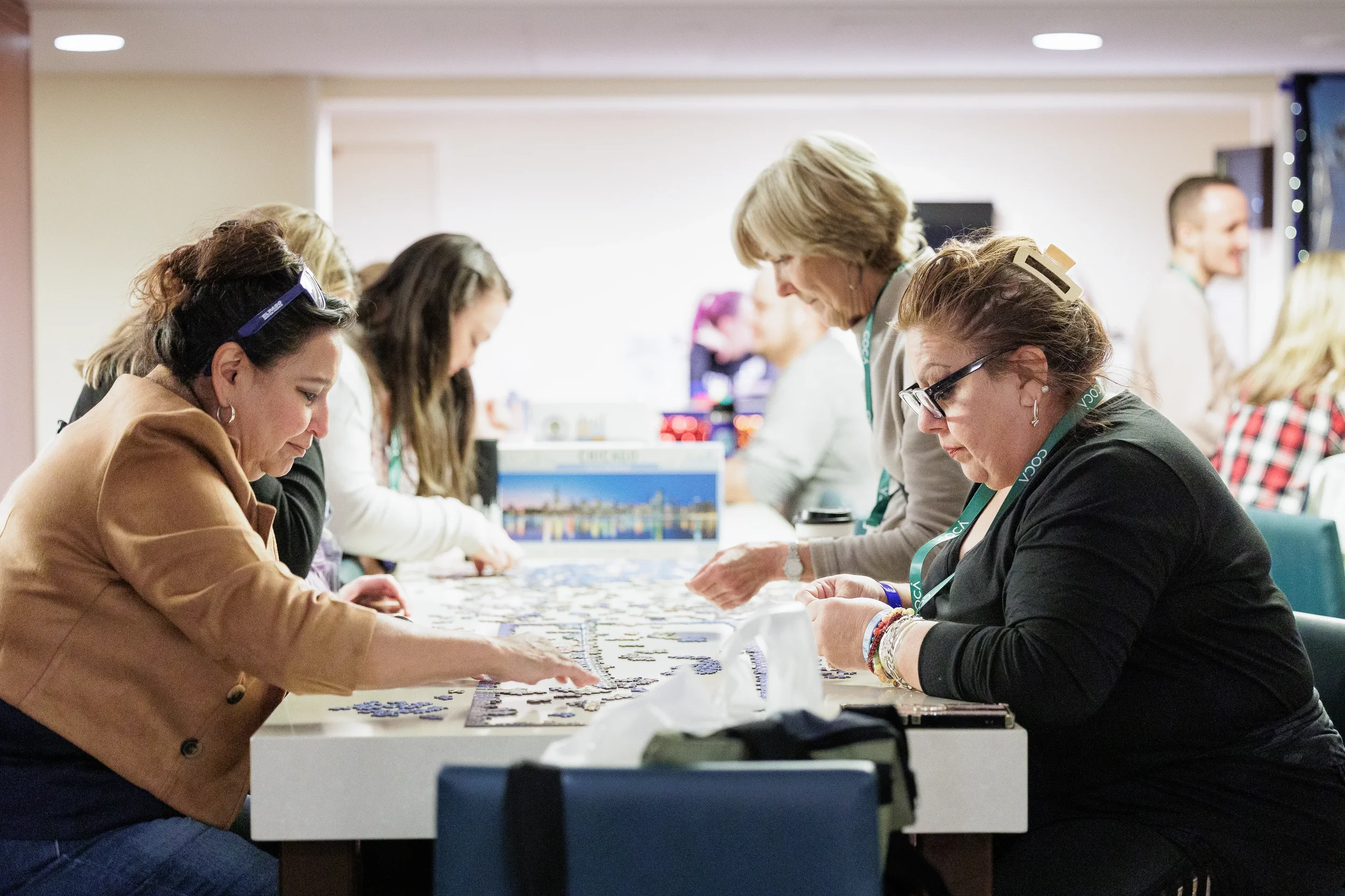 Attendees work together on a Chicago skyline jigsaw puzzle during break at Chicago nonprofit conference
