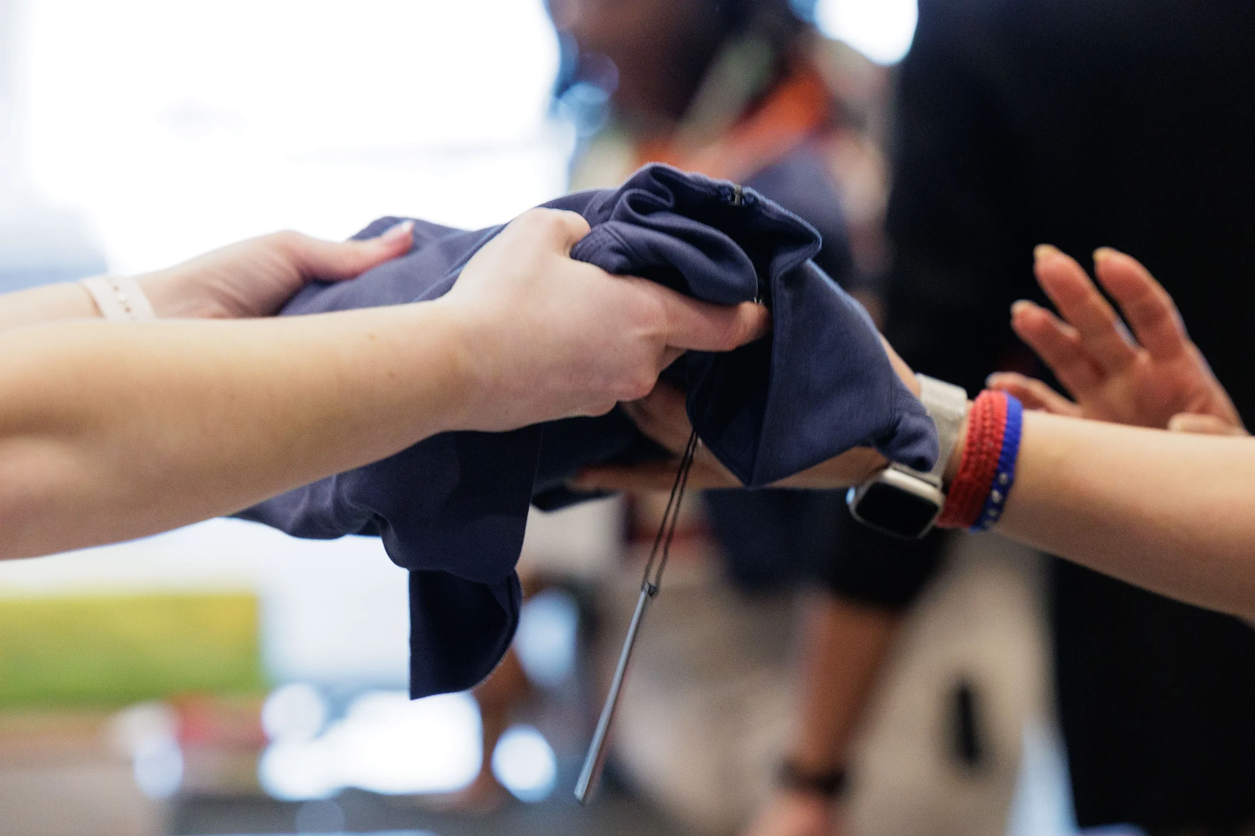 Staff member hands branded merchandise to attendee at Orlando corporate conference registration
