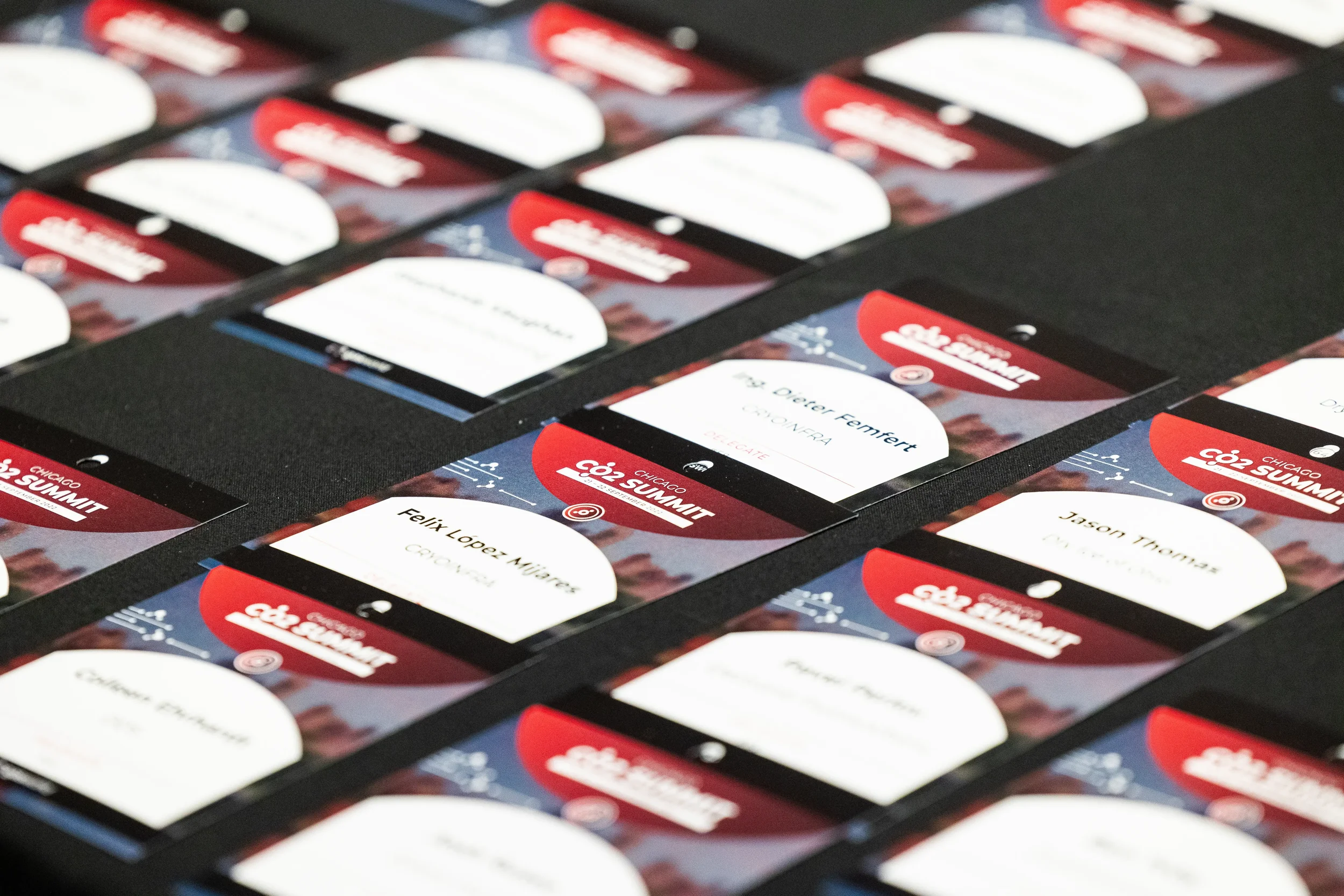 Rows of branded conference name badges arranged on registration table at Orlando event