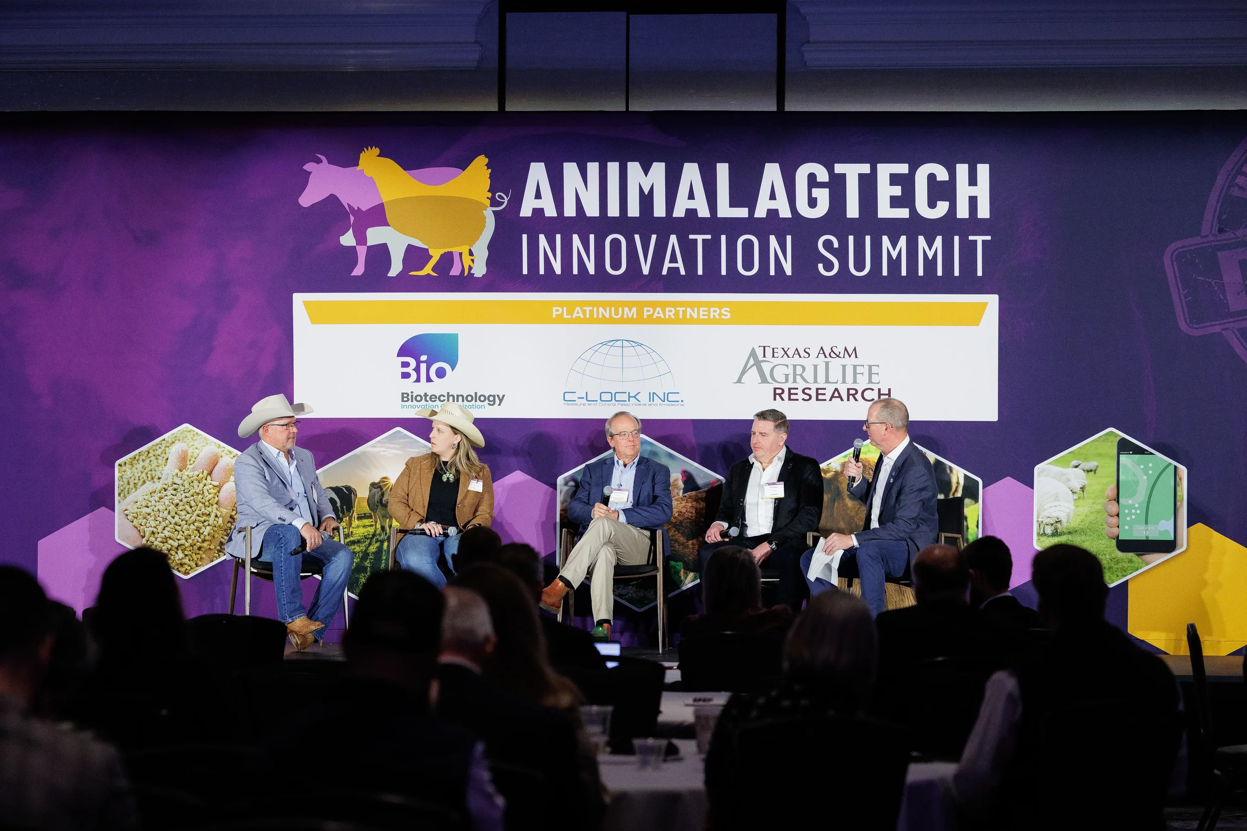 Five panelists including two in cowboy hats discuss on branded stage at Chicago summit